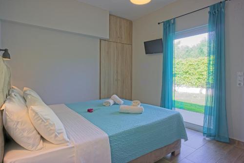 a bedroom with a bed with towels on it at Dimitra Apartments in Kanali
