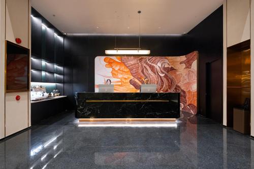 a lobby with a large painting on the wall at Dream Palace Ben Thanh Grand Hotel in Ho Chi Minh City