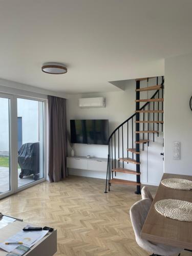 a living room with a staircase and a television at Kingdomki in Kopalino