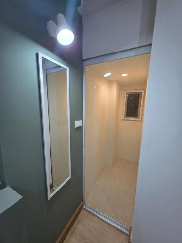 a bathroom with a mirror and a walk in shower at PKK hotel Residence in Bang Phli