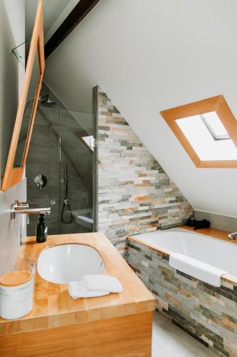 a bathroom with a sink and a bath tub at La Paulowna Boutique Hotel in The Hague