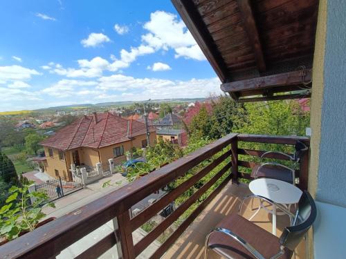 a balcony with chairs and a view of a house at Casa Ramona in Turda