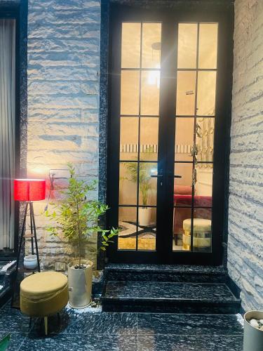 a door with a stool in front of a building at Lux Bliss Bed & Breakfast in Amritsar