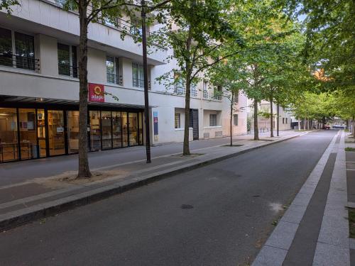 an empty street in front of a building at Le Jourdain in Paris