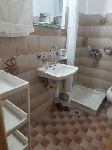 a bathroom with a sink and a toilet at Garden studio N4 in Archangelos