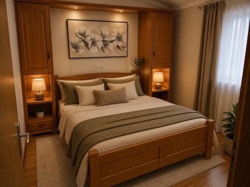 a bedroom with a large bed with two lamps at Apartments Žitna Sun in Vir