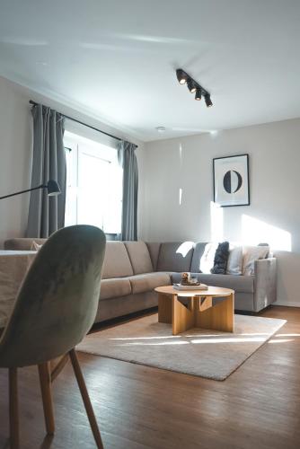 a living room with a couch and a coffee table at Oskar Apartments in Neustift im Stubaital