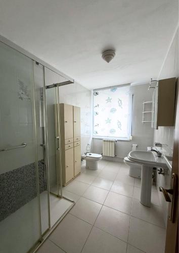 a bathroom with a shower and a toilet and a sink at Casa Ramona en Foz in Foz