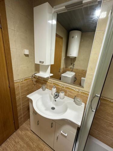 a bathroom with a sink and a mirror at Mercury Apartments Budva in Budva