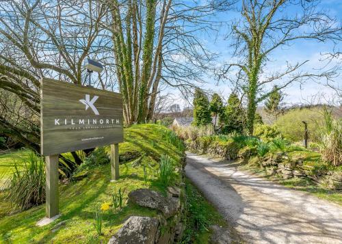 a sign for a garden with a dirt road at Kilminorth Cottages in Trelaske