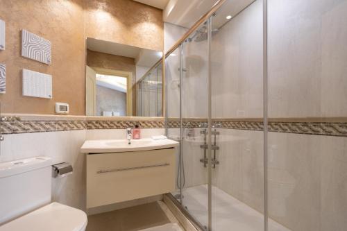 a bathroom with a shower and a toilet and a sink at El Safwa Resort New Cairo in Cairo
