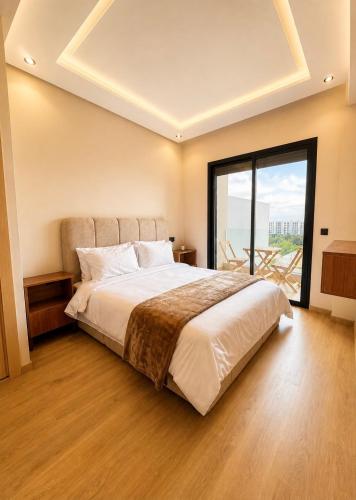 a bedroom with a large bed and a large window at Oasis Hills - Modern & Cosy 1BR with Balcony - Central in Casablanca