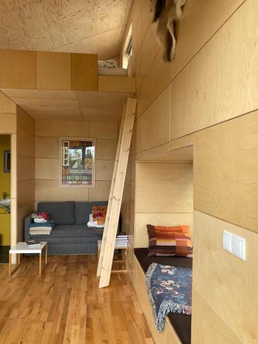a living room with a couch and a bunk bed at Guesthouse With Lake View in Veiðilundur