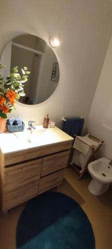 a bathroom with a sink and a mirror and a toilet at Azurara Beach Nest in Azurara
