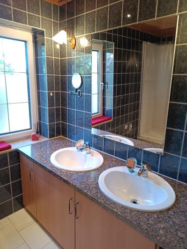 a bathroom with two sinks and a mirror at Fewo Frieda in Seehausen