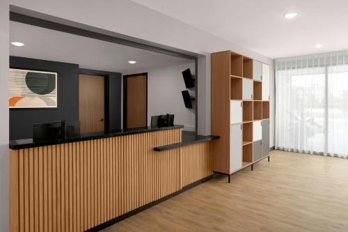 an office lobby with a reception desk and shelves at StudioRes by Marriott Mesa in Mesa