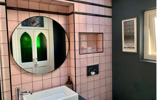 a bathroom with a mirror and a sink at Norwood in Rushbrooke