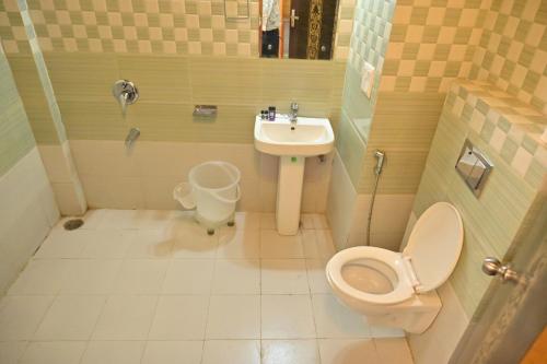 a small bathroom with a toilet and a sink at Mashobra Heights By shrpl in Kīar