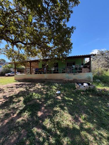 a house with a tree in front of it at Rancho dos dourados in Três Marias