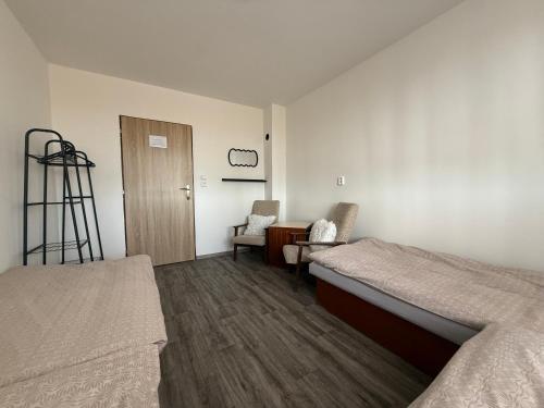 a room with two beds and a desk and a chair at SK Delfín Jesenice Cheb in Cheb