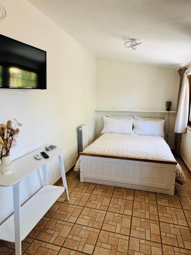 a bedroom with a bed and a desk and a tv at Anna House in Fiumicino