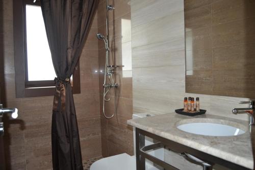 a bathroom with a sink and a shower at Encosta do Sossego in Cabeceiras de Basto