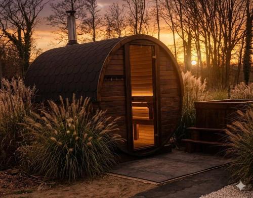 a small dome house in a garden at sunset at Apartamenty Koło Brzegu in Gąski