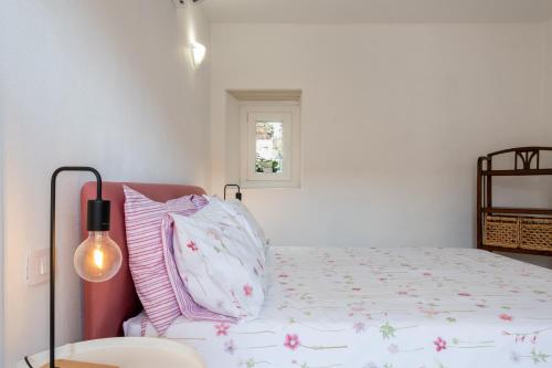 a bedroom with a bed and a lamp at Casa La Barancina in Cittiglio