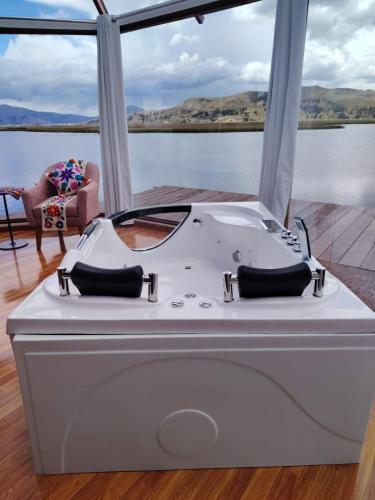 a white tub sitting on the deck of a boat at Titicaca Magical Lodge Peru in Puno