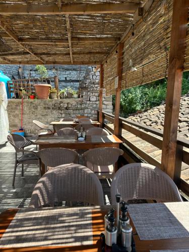 an outdoor dining area with tables and chairs at Bujtina Bega in Berat