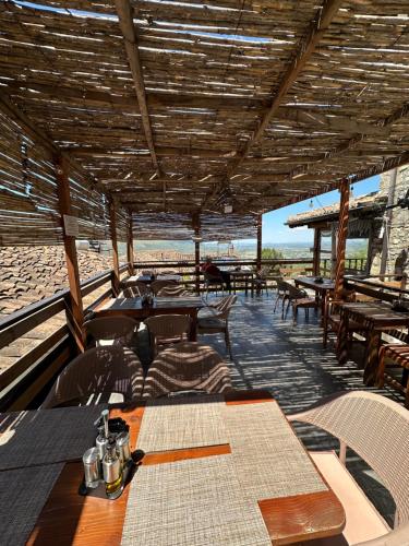a restaurant with tables and chairs on the beach at Bujtina Bega in Berat