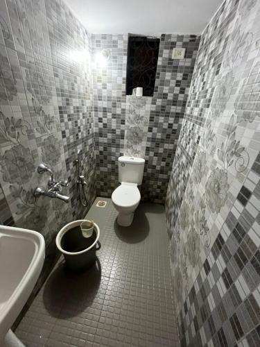 a bathroom with a toilet and a sink and a tub at Aura Calangute in Calangute