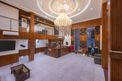 a lobby of a hotel with a chandelier at Hotel Asiia Holiday with Swimming Pool -Central Heated and Air Cooled, Near mall road in Kasol