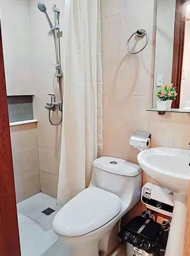 a bathroom with a toilet and a sink at A Comfy Place in Tagaytay in Sampong