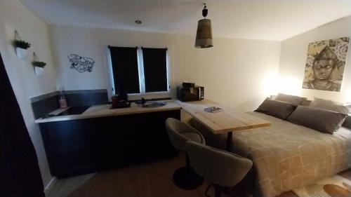 a bedroom with a bed with a desk and a table at La Vieille Bastide Suite & Spa in Lorgues