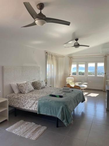 a bedroom with a bed and a ceiling fan at Villa Aqua Vista in Jávea