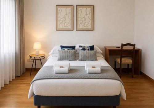 a bedroom with a bed with two pillows on it at Entre Ilhas in Horta