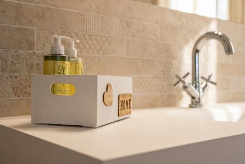 a bathroom counter with a bottle of soap and a sink at Il Collina - Poets'Vista in La Spezia