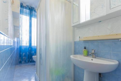 a blue bathroom with a sink and a toilet at Casa Azzurra in Portoferraio
