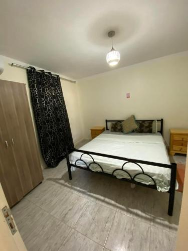 a bedroom with a bed and a closet and a door at Djerba Sérénité in Houmt Souk