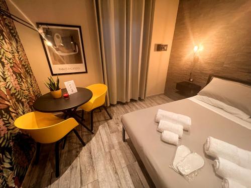 a hotel room with a bed and a small table at Kalasó Design Guest House - Rome Airport in Fiumicino