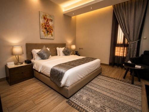 a bedroom with a large bed and a window at مسكن نون للشقق المخدومة in Jeddah