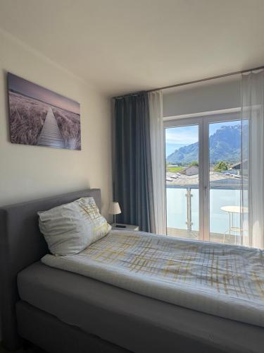 a bedroom with a bed and a large window at Apartment Birnbaum in Wals