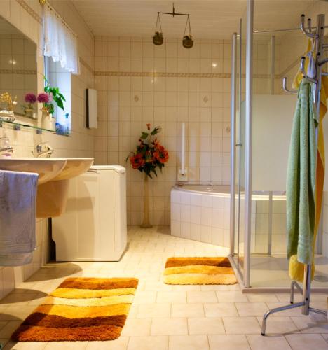 a bathroom with a shower and a sink and a tub at auf der Muehle zwei in Zerbst