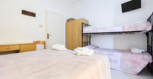 two beds in a room with two bunk beds at Hotel Maria Luisa in Rimini