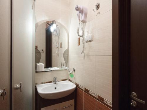 a bathroom with a sink and a mirror at Asotel in Kharkiv