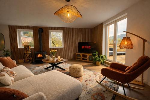 a living room with a couch and a tv at Le lofty in Stoumont