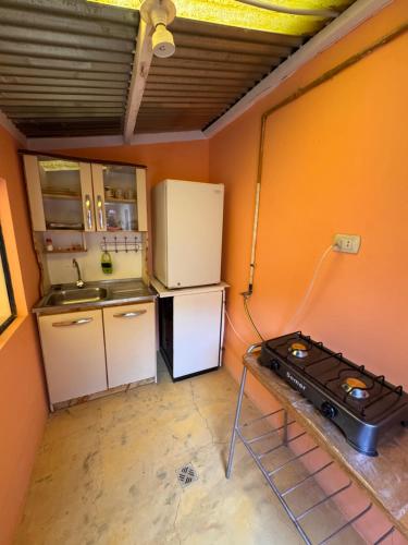 a kitchen with two refrigerators and a stove at Casa Oruro Valvic in Oruro