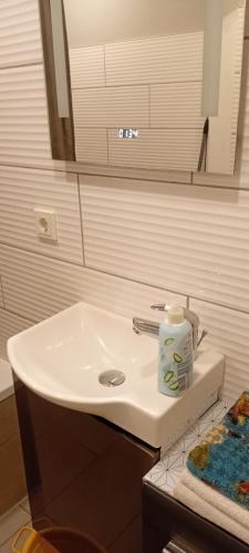 a bathroom with a white sink and a mirror at Saarlouis in Saarlouis