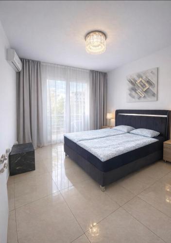 a bedroom with a large bed and a large window at Lapta SEL in Ayios Dhometios
